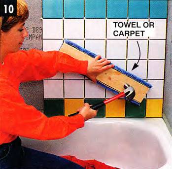 Level all tiles with a padded wood block and a hammer