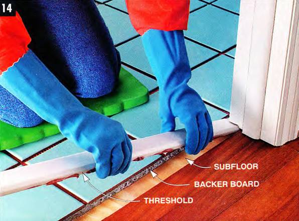 Glue your threshold directly to the subfloor to keep it level with the tiles
