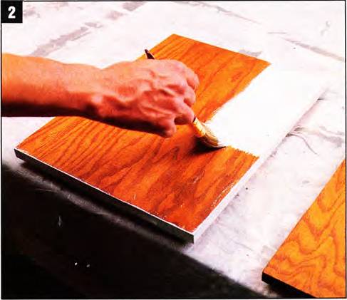 Put blocks of wood on a table and line up the doors. Start painting the edges, then proceed on the backs, and finally the door faces. Use primer and two topcoats.