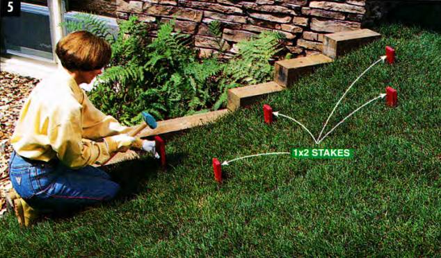 Drive short stakes into sod that's on an incline