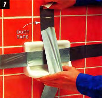 Secure the soap dish to the wall with duct tape and leave it overnight