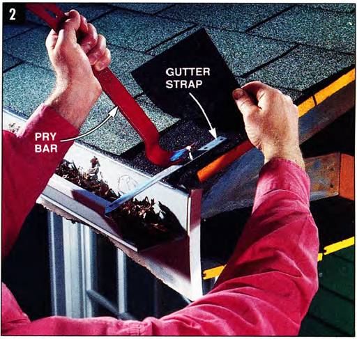 Use a pry bar to release the gutter strap and lower the gutter