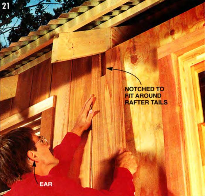 Install the tongue-and-groove siding, notching it to fit them around the rafter tails