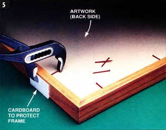 Use brad nails to hold the artwork