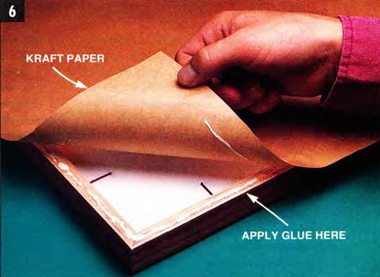 Glue an oversized piece of brown kraft paper to the back of the frame