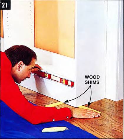 Use wood shims to level the shelving tight against the wall