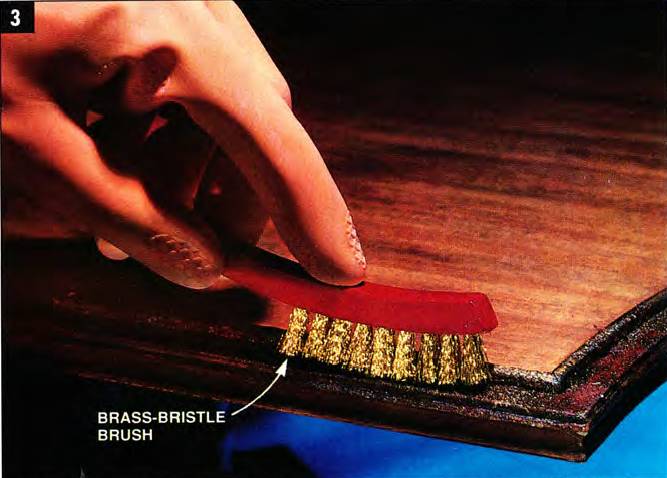 Use a brass-bristle brush to loosen the old finish and the stripper along edges and corners