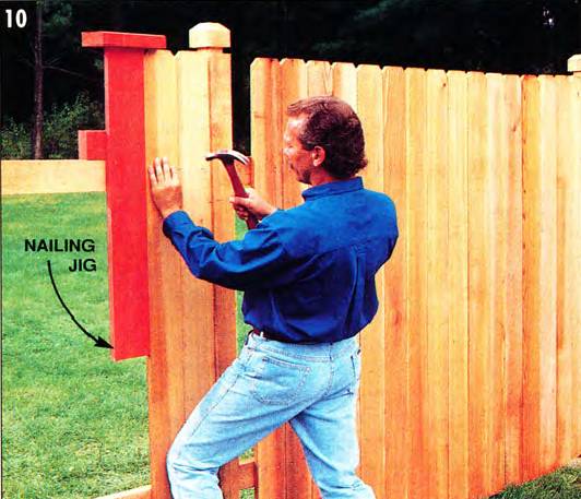 Use a nailing jig to align the fence boards accurately above the upper stringer