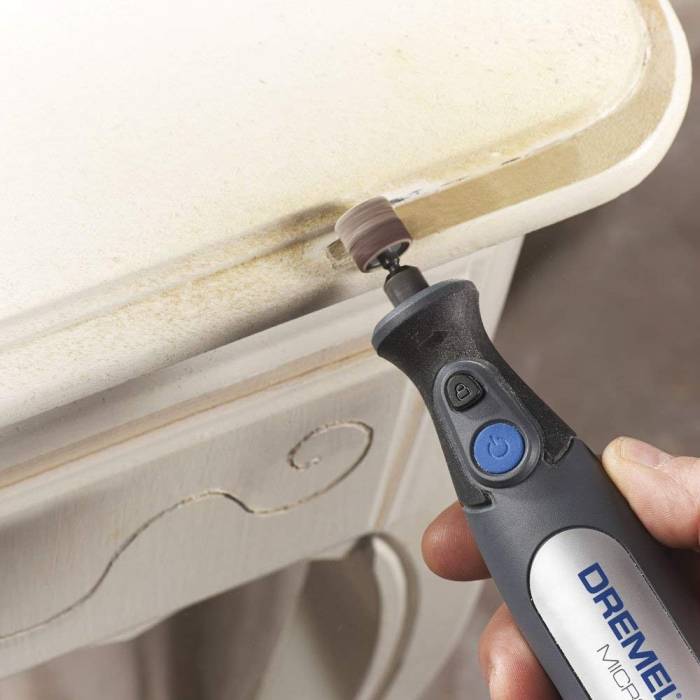 this person is sanding all nooks and crannies with a sanding drum accessory in their cordless dremel
