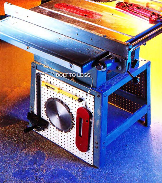 Keep all your table saw accessories handy by bolting a pegboard panel on the iron legs of your table saw stand